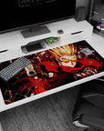 40x20 inches anime desk pad showing spiky blond shooter in crimson coat and orange shades aiming a pistol forward.