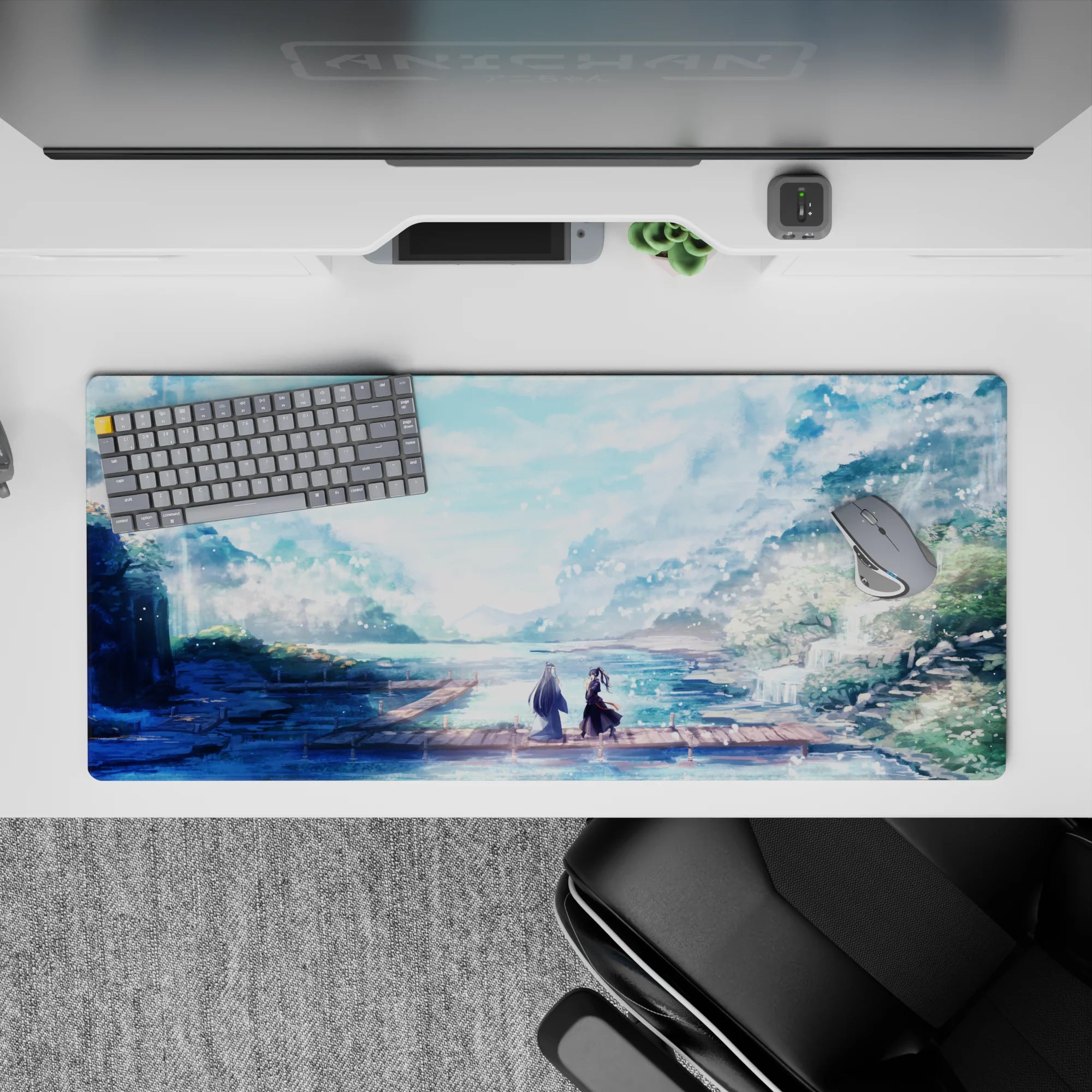 Anime desk pad 36x16 inches featuring serene landscape with figures on a dock, pastel colors, and falling petals.