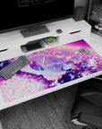Yuyuko Saigyouji with a fan amid glowing butterflies on an anime desk pad 40x20 inches.