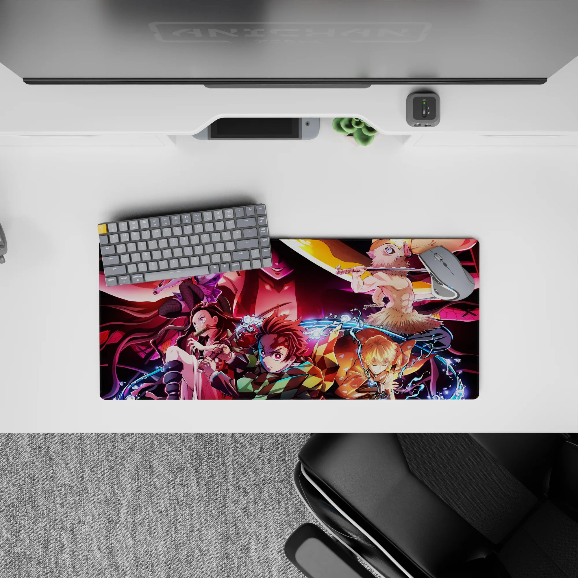 Anime mouse pad 28x12 inches featuring Demon Slayer characters Tanjiro, Nezuko, Zenitsu, and Inosuke battling Daki.