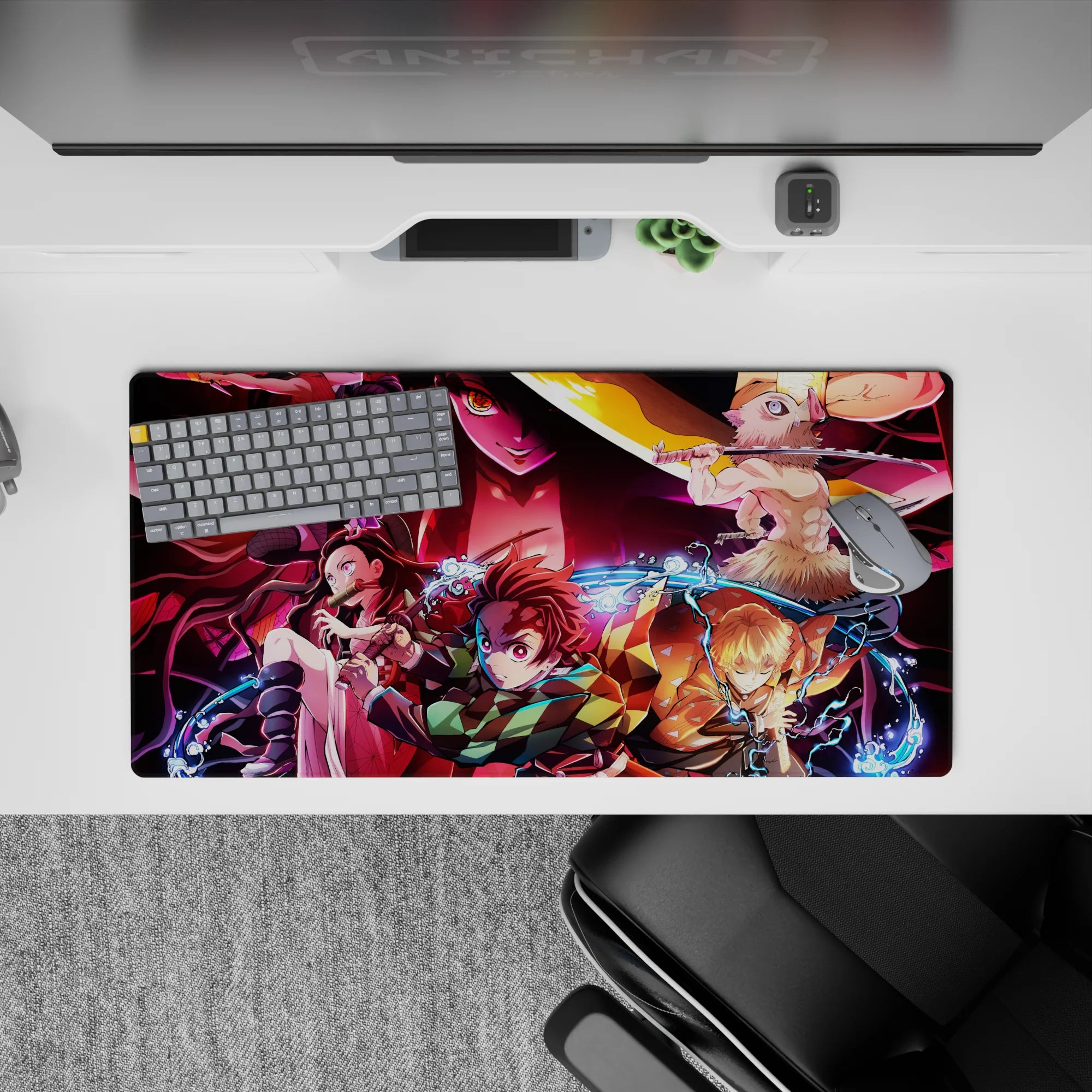 Anime mouse pad 32x16 inches featuring Demon Slayer squad Tanjiro, Nezuko, Zenitsu, Inosuke battling Daki amidst chaos.