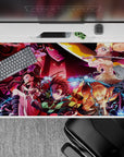 Anime desk pad featuring Demon Slayer characters Tanjiro, Nezuko, Zenitsu, and Inosuke battling Daki, size 40x20 inches.