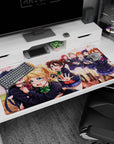 40x20 inches anime desk pad showing Umi hugging Eli while Nico reaches out, lively school idol moment.