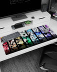 36x16 inches desk mat showing five anime girls posing in stacked panels, ribbons and frills, glossy highlights.