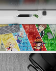 KonoSuba anime desk pad 36x16 inches featuring Aqua, Darkness, Megumin, and Kazuma in a vibrant collage of chaos.