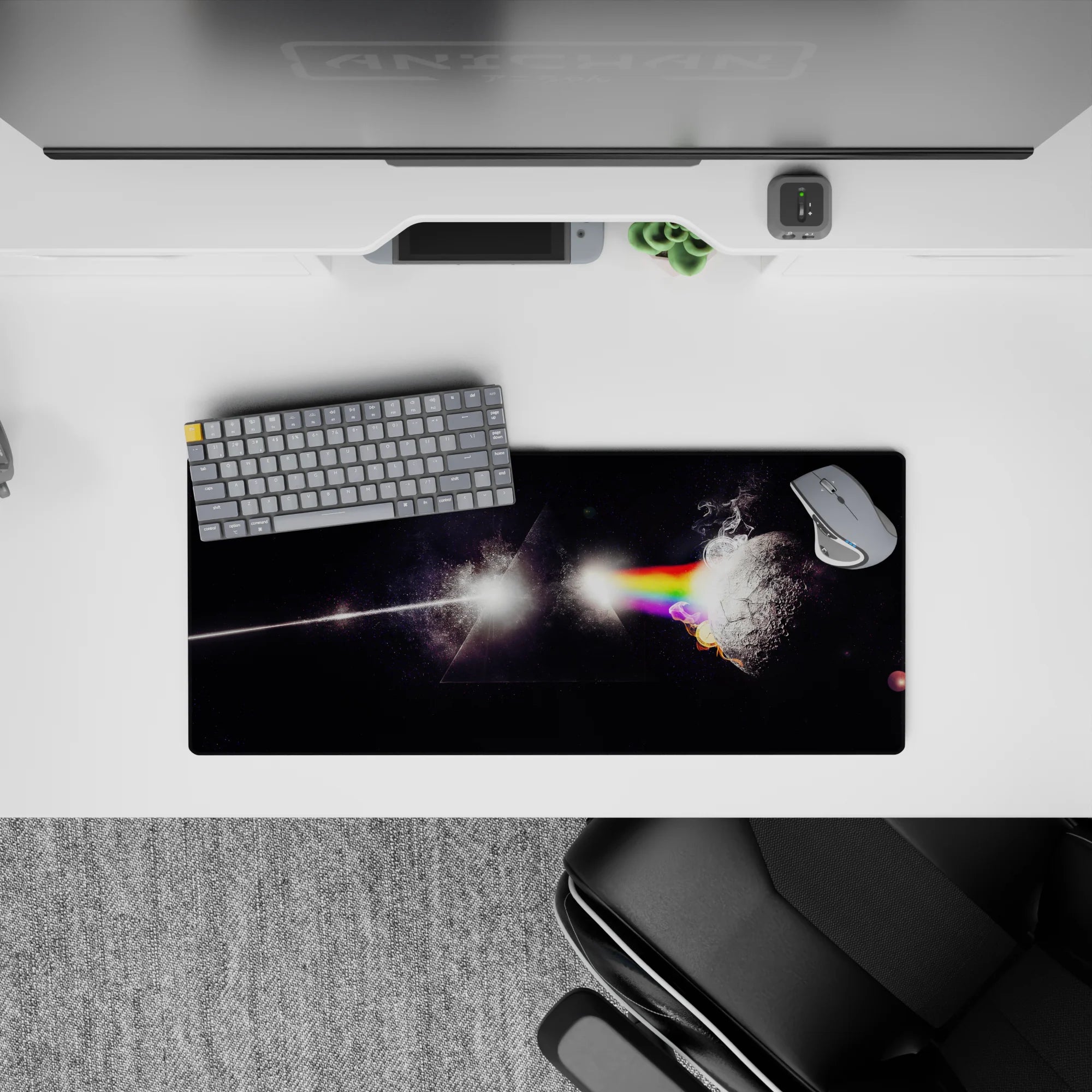 Moody black starlight mouse pad 28x12 inches with glowing rainbow bands and smoky prism light.