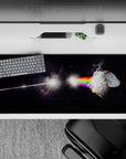 Moody deep-black desk pad 36x16 inches with smoky rainbow glow and playful sci-fi starlight vibe.
