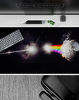 Dark starlit desk pad 40x20 inches with glowing rainbow bands and smoky edges for a calming sci-fi mood.
