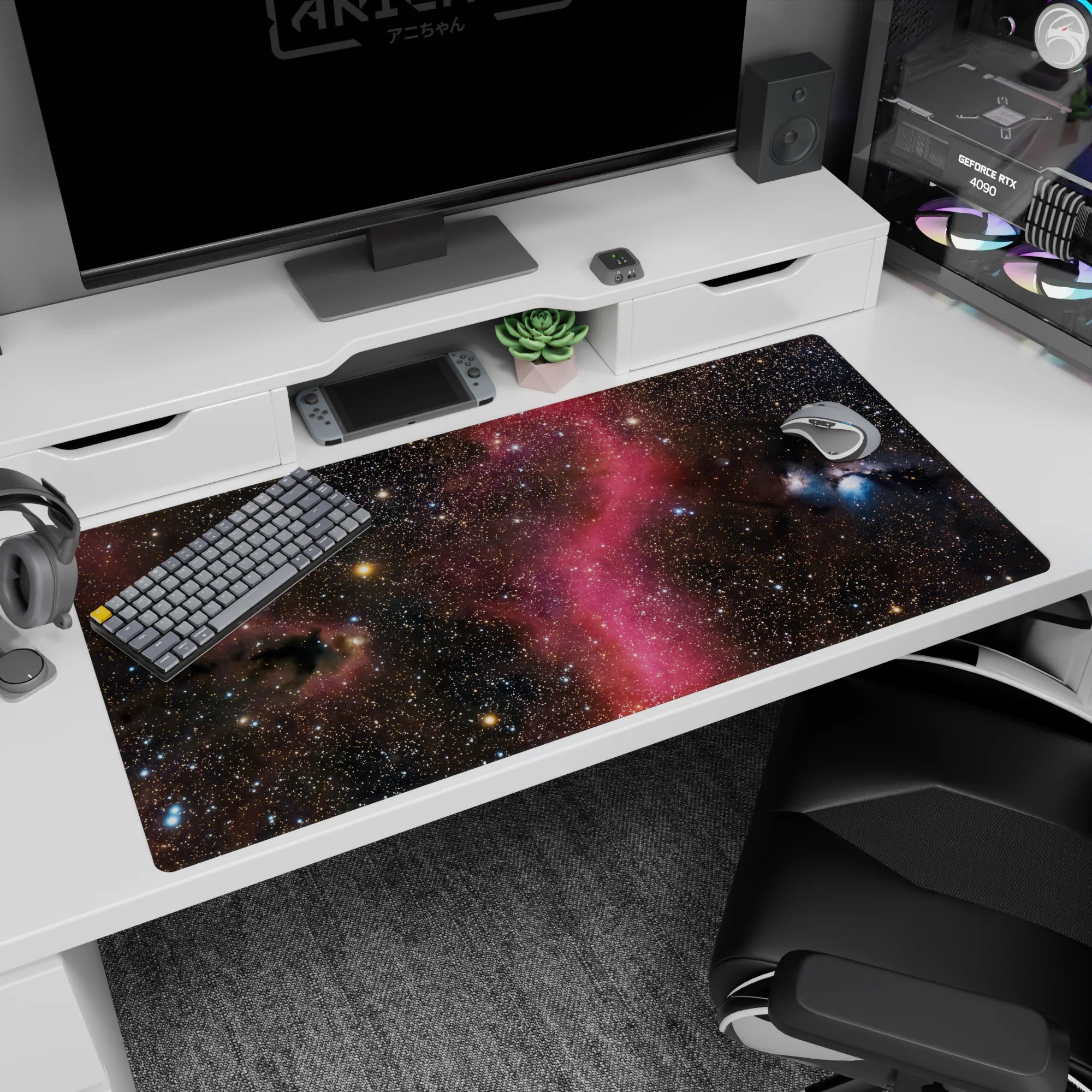 Deep space scene desk pad, 40x20 inches, featuring tiny star-specks and a cotton candy pink nebula.