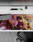 36x16 inches anime desk pad in warm gold cliffs and violet mist, cozy dreamy adventure vibe.