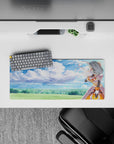 Darkness from Konosuba winks under a dreamy sky; 28x12 inch anime mouse pad with watercolor clouds and bold armor.