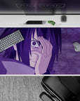 Anime mouse pad featuring Sasuke Uchiha with Mangekyō Sharingan from Naruto, size 40x20 inches, purples and intense design.
