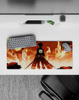 Mouse pad featuring Eren Yeager from Attack on Titan, size 28x12 inches, standing in a fiery cityscape, ready for battle.
