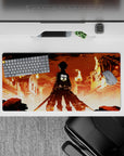 Anime mouse pad 32x16 inches featuring Eren Yeager from Attack on Titan standing against a fiery city backdrop.