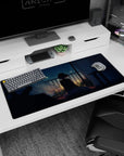Shy anime girl sitting by a balcony at night with twinkling city lights desk pad 36x16 inches.