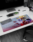 Silver-haired anime heroine twirling in dress and blue cape with petals on desk pad 36x16 inches.