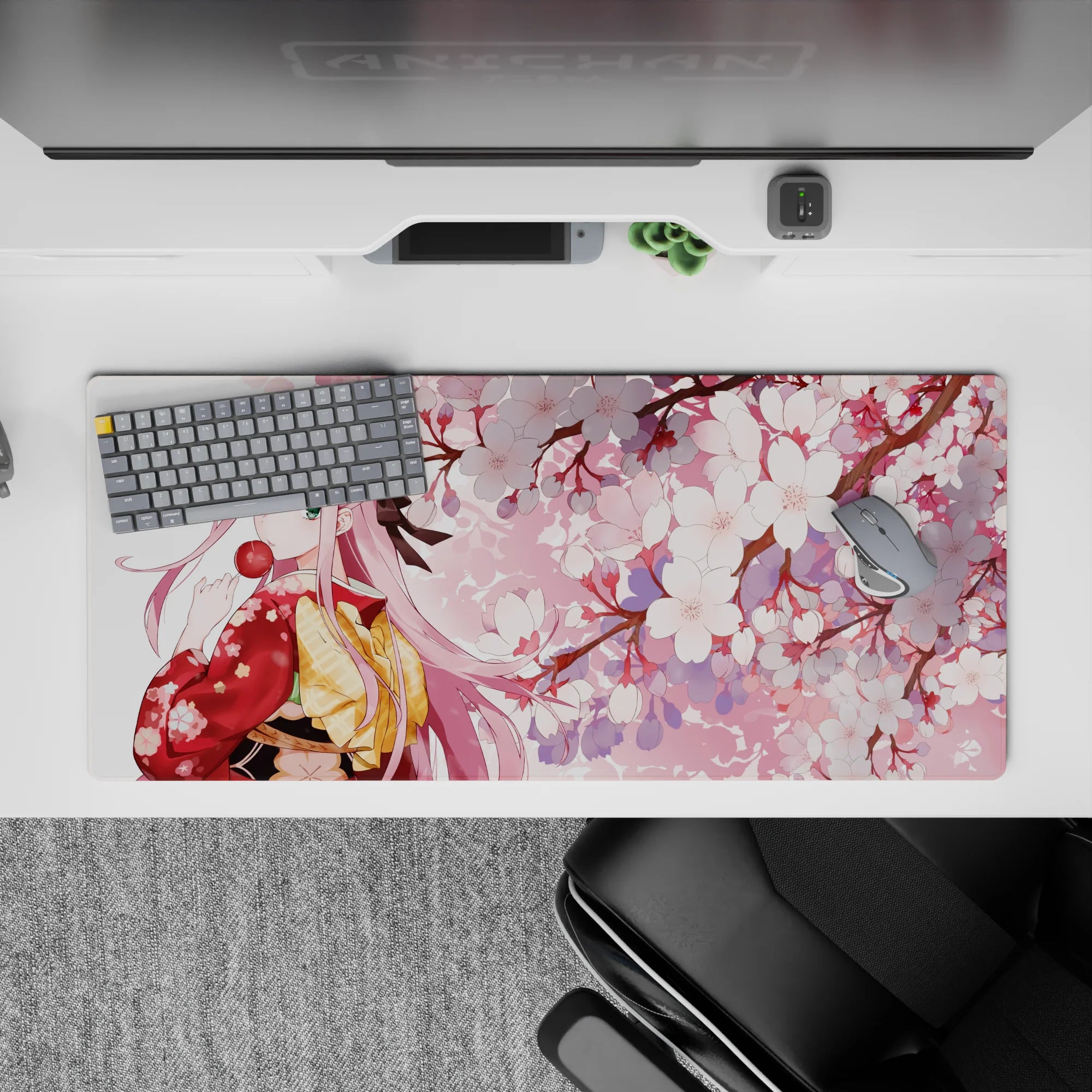 36x16 inches desk pad with Zero Two in a traditional kimono, surrounded by cherry blossoms and a tranquil sakura tree atmosphere.