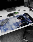 Anime girl under clear umbrella with tied-back black hair and snowflake scarf, desk pad 40x20 inches.