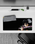 Mikasa Ackerman from Attack on Titan mouse pad, 28x12 inches, mid-battle scene with a forest green cloak and intense gaze.