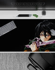 Anime desk pad featuring Mikasa Ackerman from Attack on Titan, size 40x20 inches, intense battle scene with green cloak.