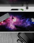 Purple haze and electric blue on midnight black desk pad 40x20 inches for a calm cosmic mood.
