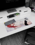 28x12 inches anime girl mouse pad showing red-haired girl in white camisole on pale gray sheets with sly look.