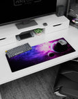 Space scene 32x12 inches mouse pad featuring two dark planets drifting through purple-pink nebula clouds.