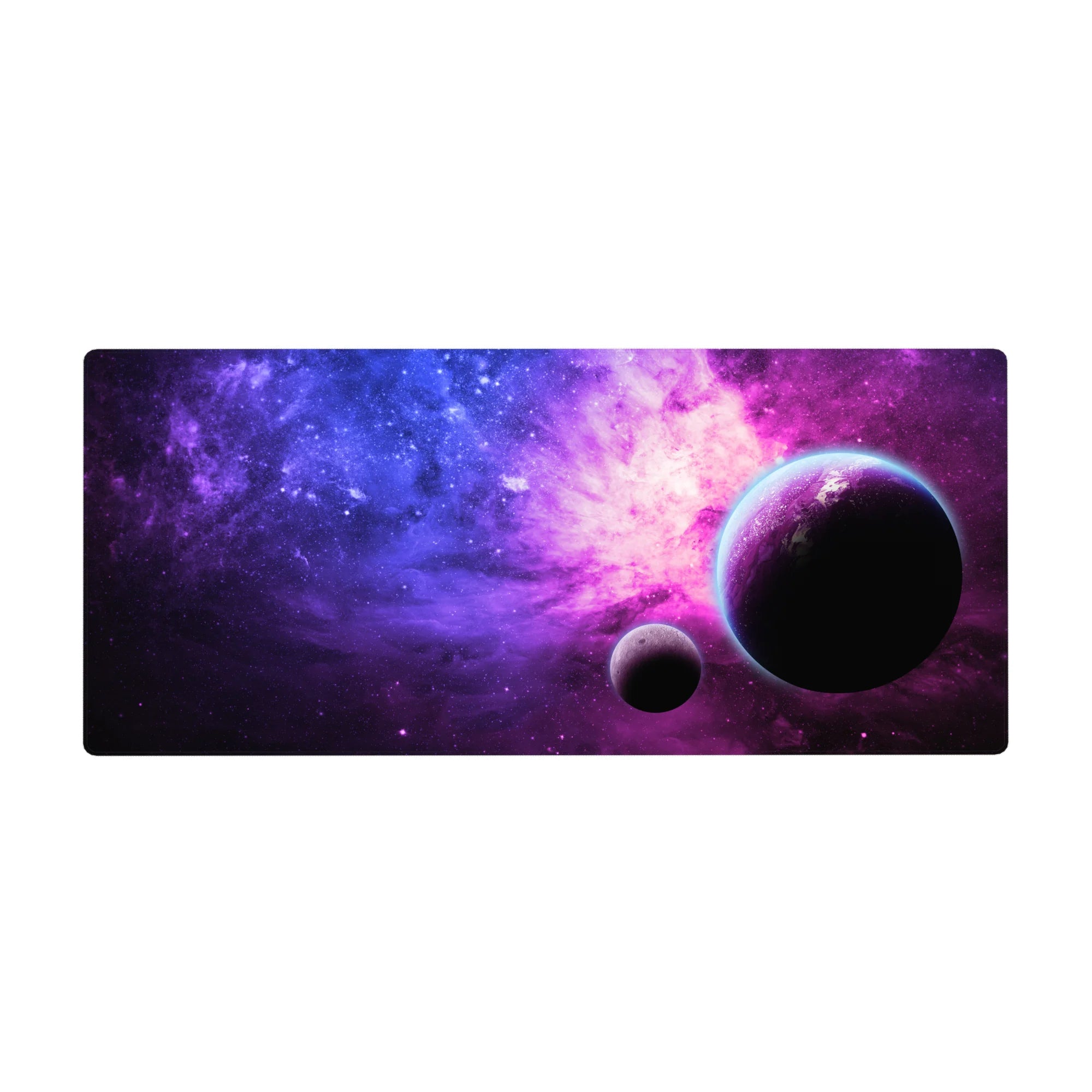 Galaxy desk pad 36x16 inches with star-speckled nebula gradient and two shadowy planets.