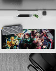 Demon Slayer anime mouse pad, 32x12 inches, featuring Tanjiro, Nezuko, Zenitsu, Inosuke, and Giyu in an epic battle scene.