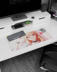 28x12 inches mouse pad showing a blonde anime cutie with long shiny hair, heart backdrop, cheeky wink.