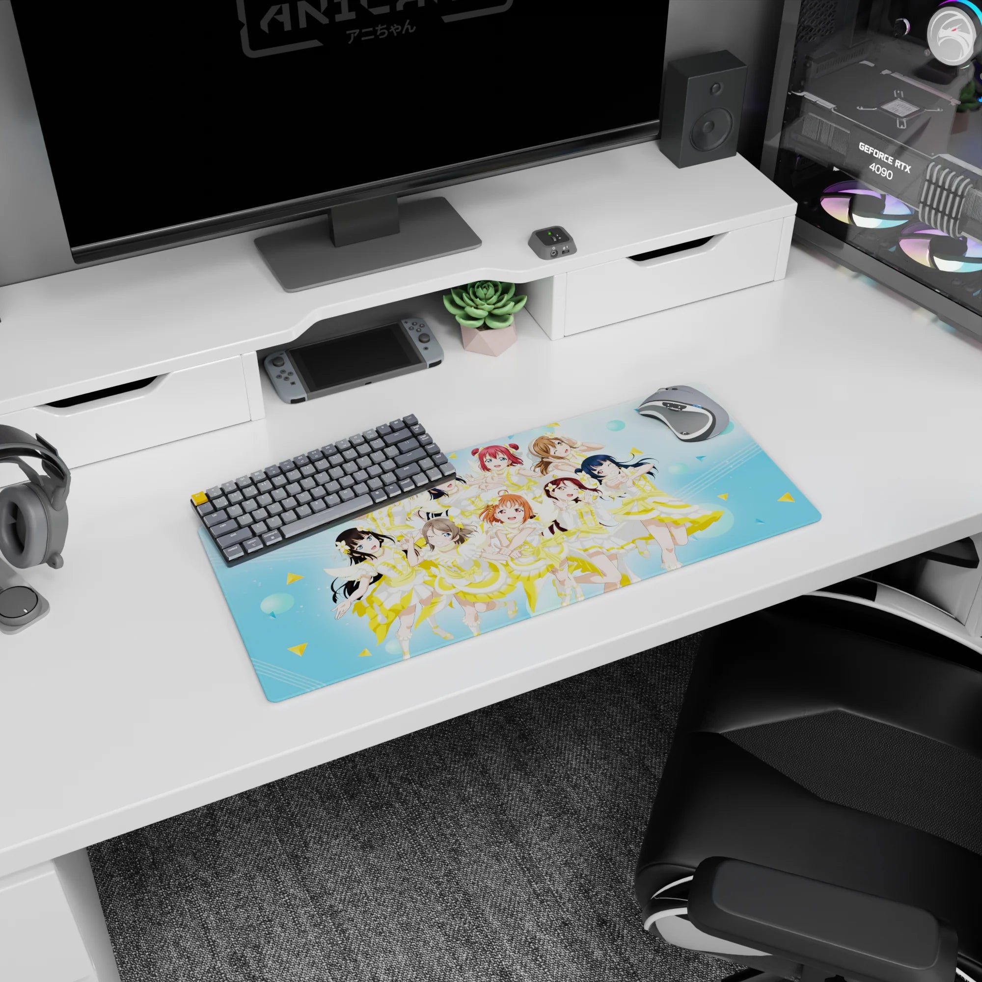 Nine cute anime idols mid-encore on a 28x12 inches mouse pad, winks and peace signs on blue dots.