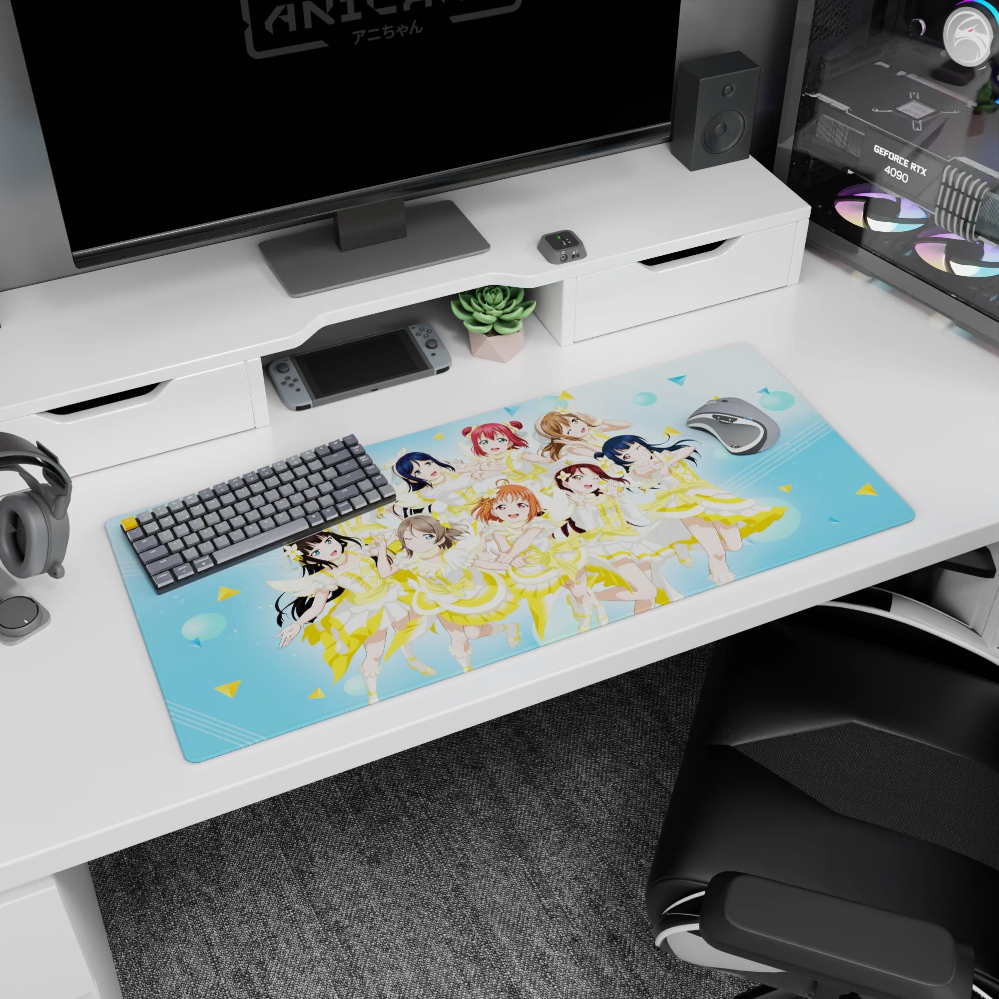 Nine anime idols mid-encore on a 36x16 inches desk pad, winks and peace signs with flower hair clips.