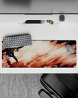 Megumin from Konosuba gazes intently, her cloak blending with flames on a 32x12 inch anime mouse pad, capturing quiet power.