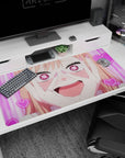 Peach-haired anime girl grinning with heart pupils on desk pad 40x20 inches, nails to cheeks.
