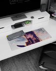 Shy blue-haired anime schoolgirl with hair clips and teasing smile on mouse pad 28x12 inches.