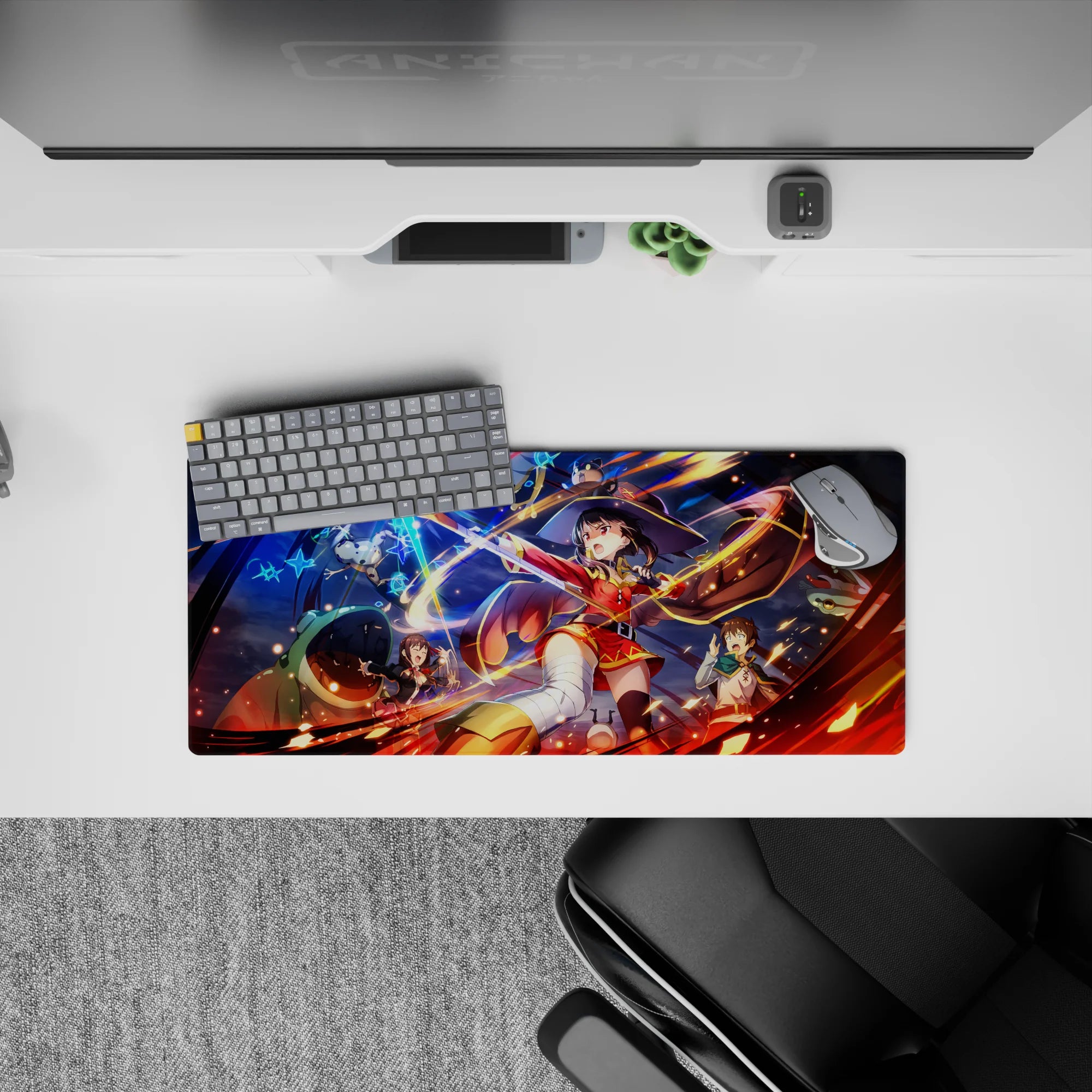Megumin from Konosuba in explosive action on a 28x12 inch anime mouse pad, surrounded by fiery spells and wild chaos.