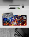 Megumin from Konosuba in explosive action on a 28x12 inch anime mouse pad, surrounded by fiery spells and wild chaos.