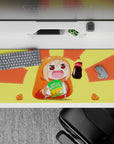 Sunny yellow-orange anime girl desk pad 36x16 inches, warm glow and playful happy gaming vibe.
