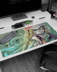 Bright green-eyed blonde anime girl gazing up on desk pad 40x20 inches, long mint-and-gold hair flowing.