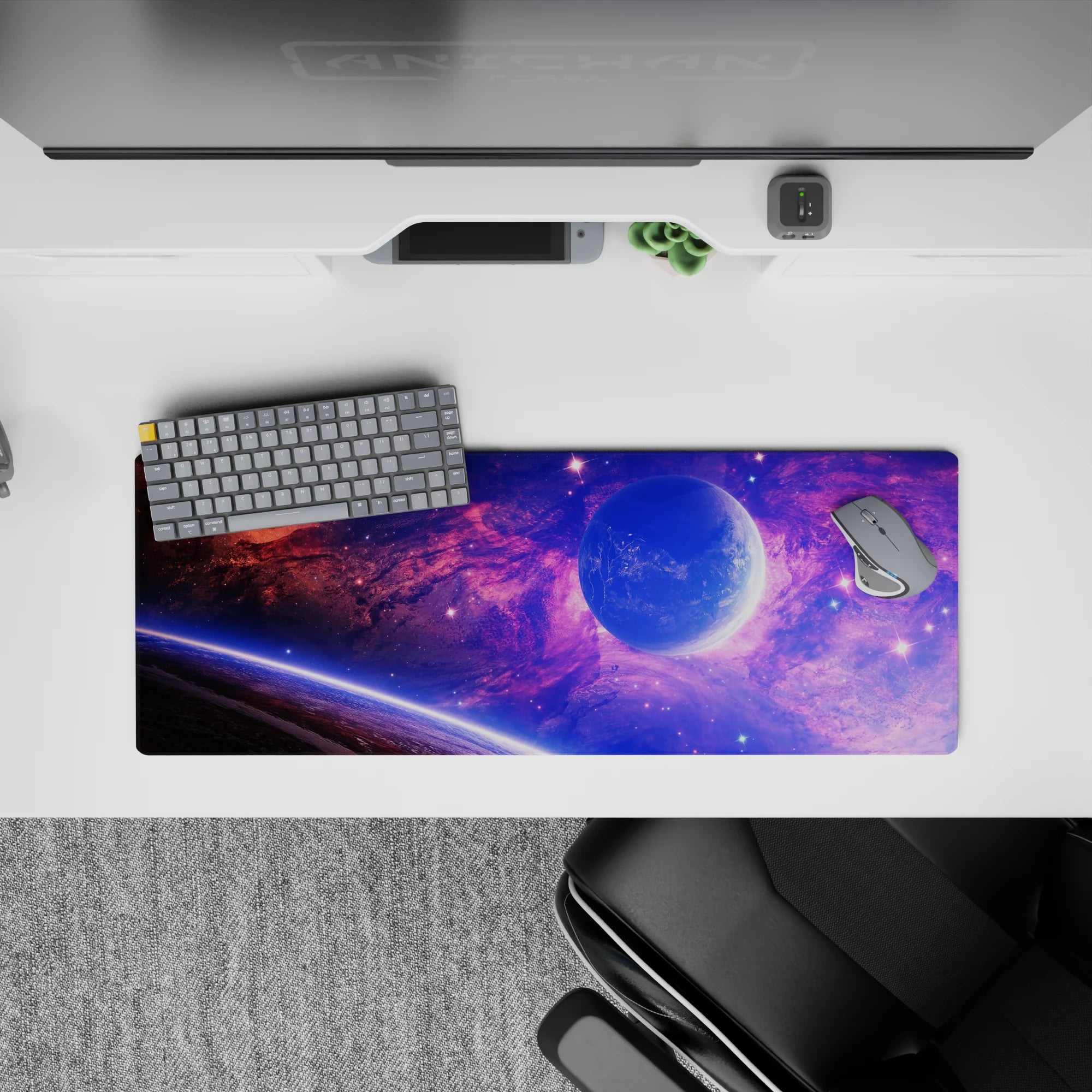Galaxy-inspired desk mouse pad with violet and blue clouds and stars, smooth surface, 32x12 inches.