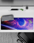 Galaxy-inspired desk mouse pad with violet and blue clouds and stars, smooth surface, 32x12 inches.