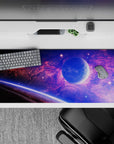 Galaxy-themed desk pad 36x16 inches with violet and blue clouds, glowing planet, and starry space design.