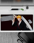 Ichigo Kurosaki silhouette on 32x16 inch mouse pad from Bleach, black robes, orange hair, Zangetsu, burgundy backdrop.