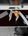 Ichigo Kurosaki silhouette on 40x20 inch desk pad, black robes, orange hair, Zangetsu sword, burgundy background, Bleach.