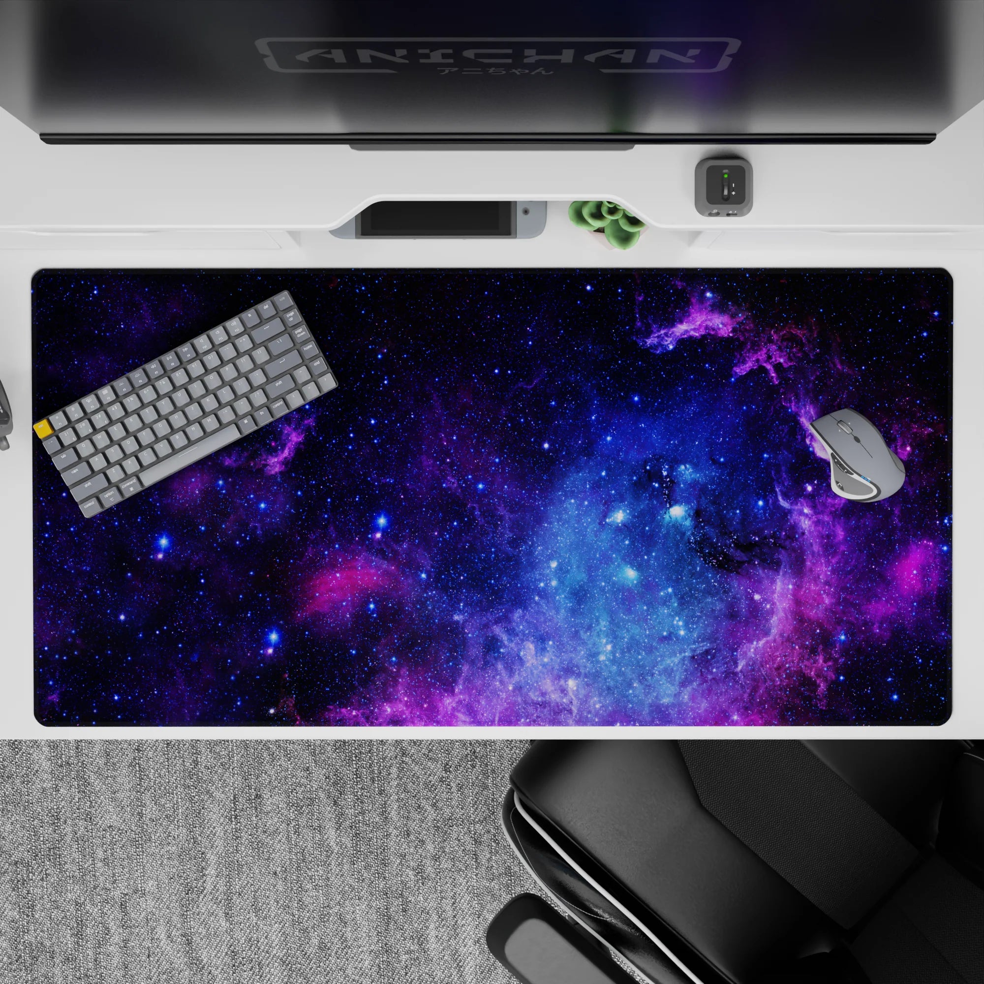 Galaxy-themed desk pad with purple, blue, and black nebula design, perfect 40x20 inch size for wide desks.
