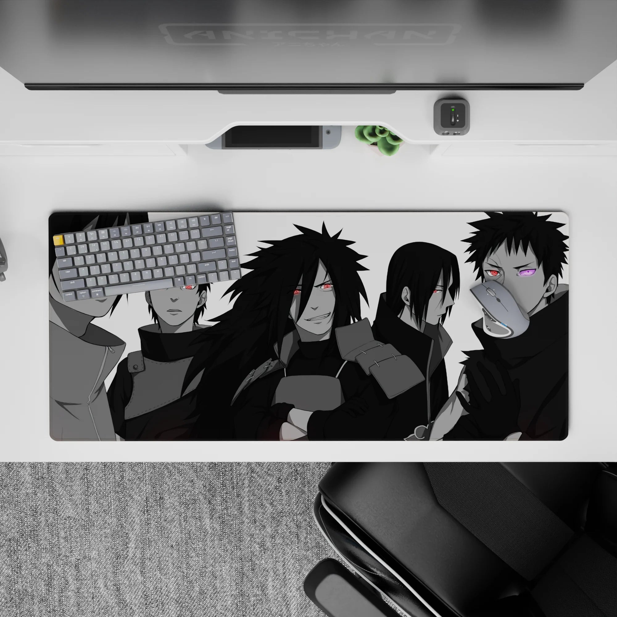 36x16 inches extended desk mat in sleek grayscale with pop red Sharingan and purple Rinnegan, dark mood.
