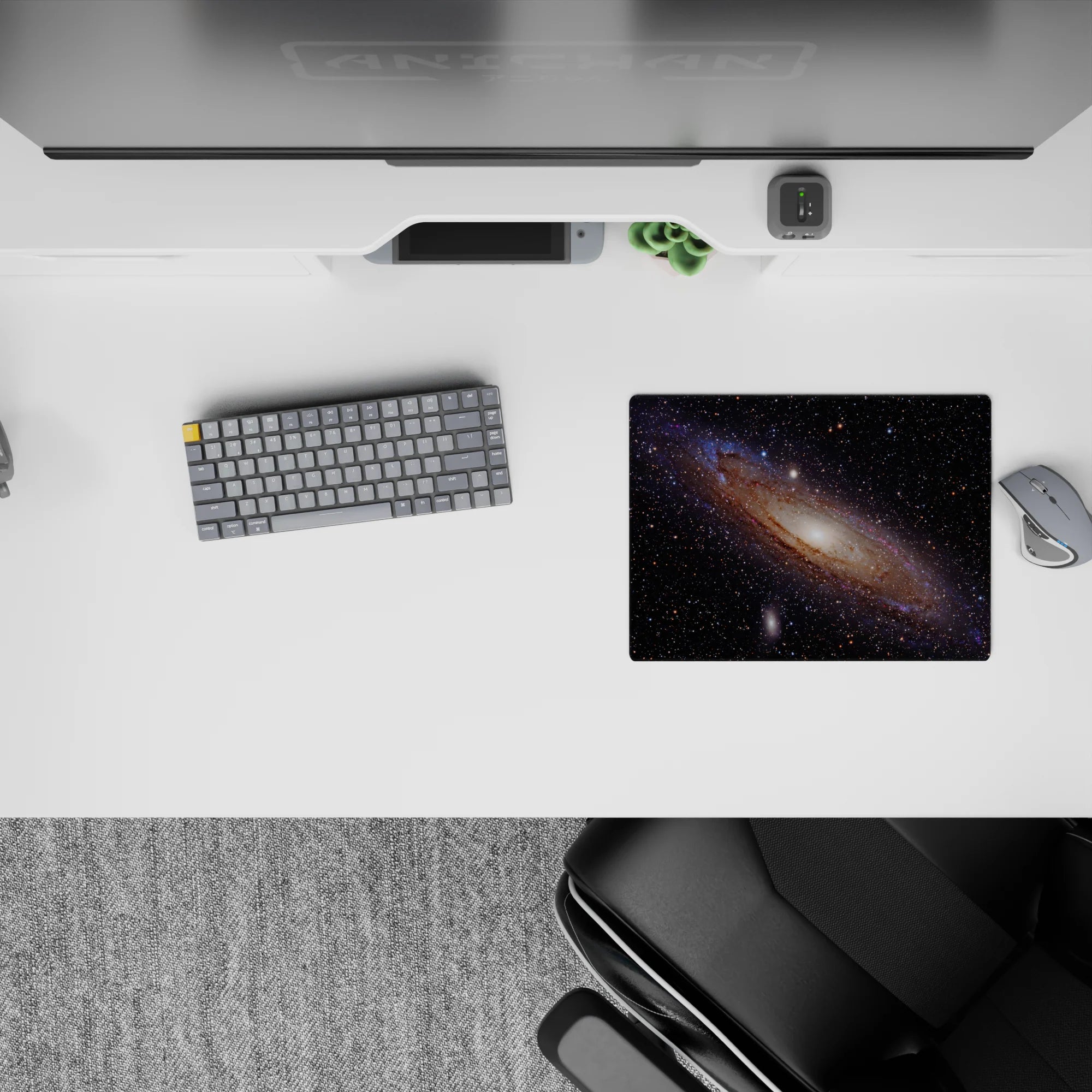 Deep black mouse pad 14x10 inches with glowing amber sparks, wispy blues, and violet haze.