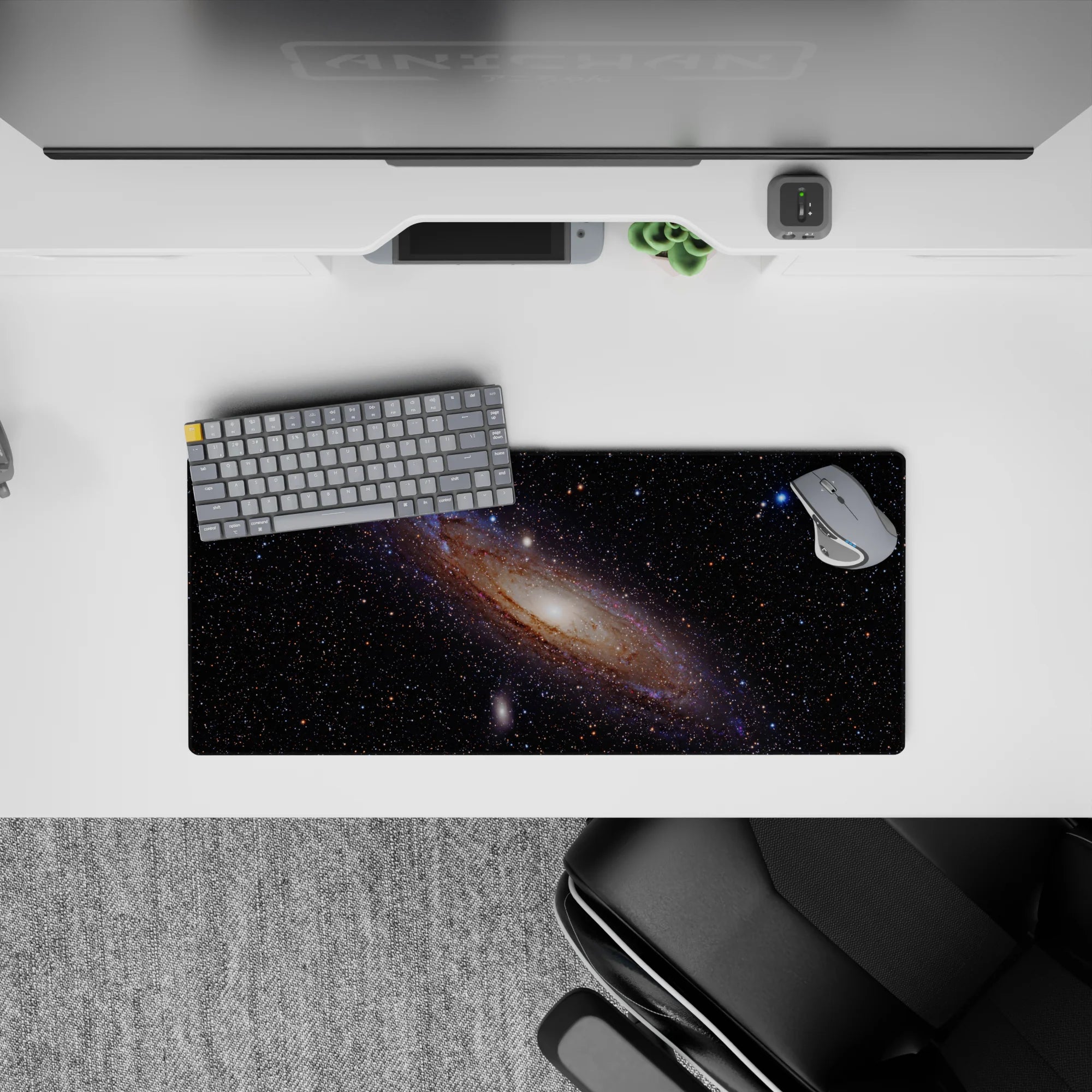Dreamy black space mouse pad 28x12 inches with wispy blues, violet haze, and amber sparks.