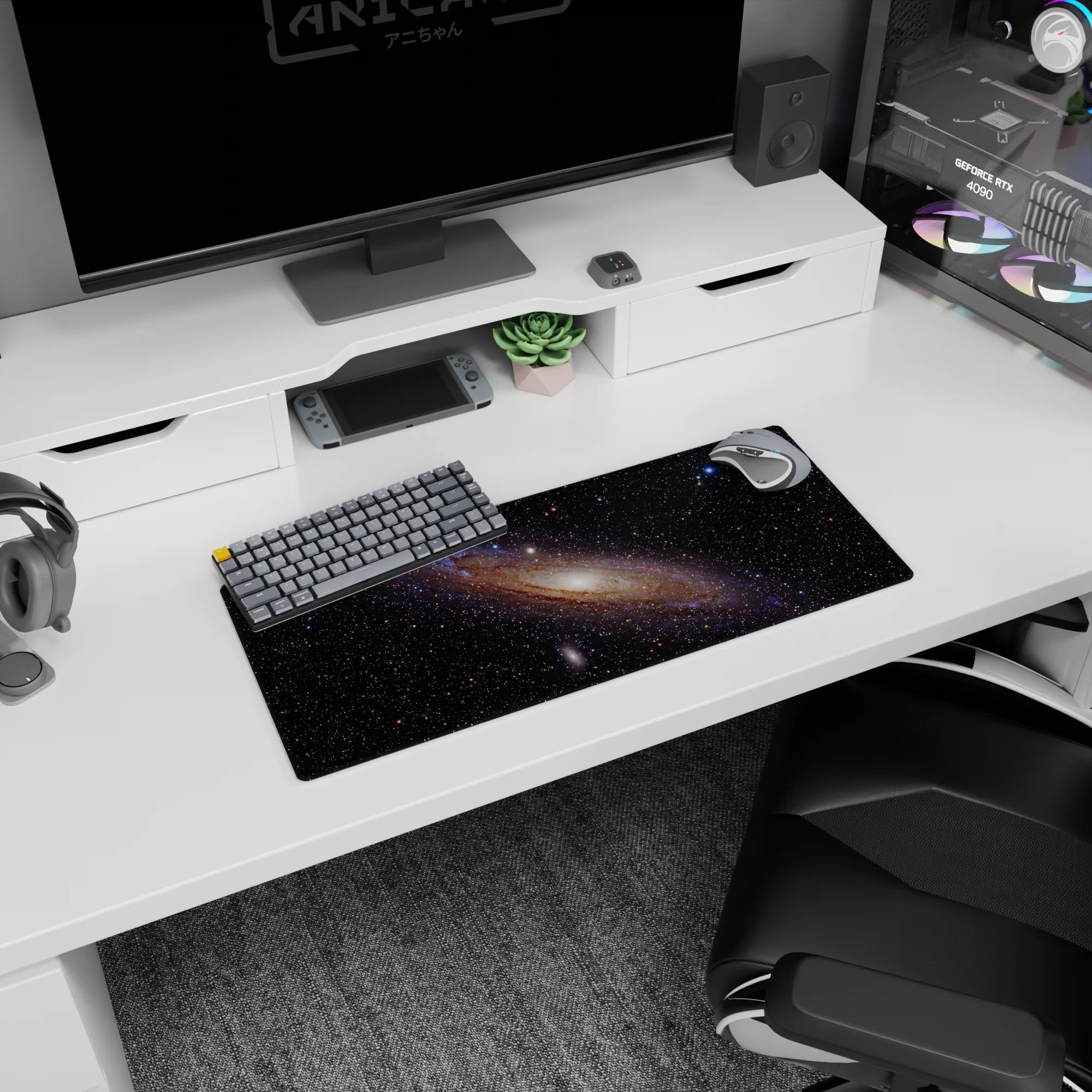 Glowing spiral nebula scene mouse pad 28x12 inches with tiny stars scattered across space.