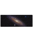 Spiral galaxy space desk mouse pad 32x12 inches with glowing core, stars, and smoky nebula swirls.